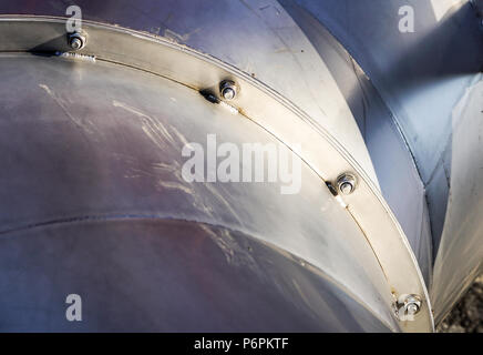 Brushed metal background with two rows of bolts Stock Photo