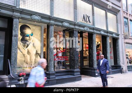 NEW YORK - JULY 3: People walk past Armani Exchange fashion store on July 3, 2013 in 5th Avenue, New York. Giorgio Armani group had 1.8 billion EUR in Stock Photo