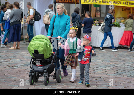 RIGA, LATVIA - JUNE 22, 2018: Summer solstice market. Family with children walking on the market. Stock Photo