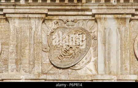 Aegis Shield with Head of Medusa, the mythological monster with the ability to turn onlookers to stone. Old stone relief on wall in Saint Mark Square, Stock Photo