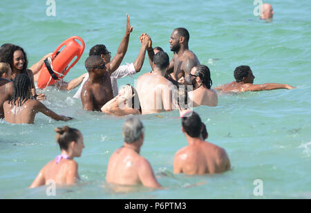 MIAMI BEACH, FL - AUGUST 16:  LeBron James showed up on location in Miami Beach for a Nike commercial. The NBA champion hopped on a bicycle and rode around the iconic Ocean Drive area with a few other riders while the cameras rolled.  Afterwards the NBA MVP LeBron James took on the task of wasting tax payers money, saying he needed an assist to get to a Justin Timberlake and Jay Z concert Friday night. The Miami Heat star than posted a video of him saying he was following 'a police escort on the wrong side of the street' to get to the concert at Sun Life Stadium. The eight-second video shows J Stock Photo