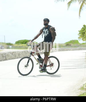 MIAMI BEACH, FL - AUGUST 16:  LeBron James showed up on location in Miami Beach for a Nike commercial. The NBA champion hopped on a bicycle and rode around the iconic Ocean Drive area with a few other riders while the cameras rolled.  Afterwards the NBA MVP LeBron James took on the task of wasting tax payers money, saying he needed an assist to get to a Justin Timberlake and Jay Z concert Friday night. The Miami Heat star than posted a video of him saying he was following 'a police escort on the wrong side of the street' to get to the concert at Sun Life Stadium. The eight-second video shows J Stock Photo