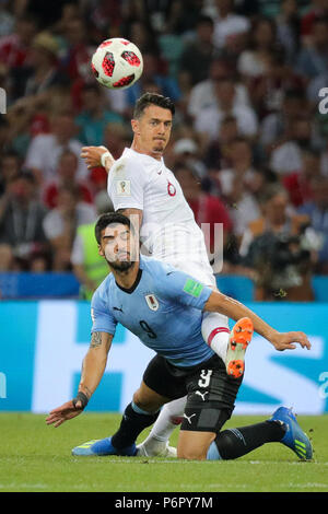 Sochi, Russia. 30th June, 2018. Soccer, World Cup 2018, Round of 16, Uruguay vs. Portugal at the Sochi stadium. Uruguay's Luis Suarez and Portugal's Jose Fonte (R) fighting for the ball. Credit: Christian Charisius/dpa/Alamy Live News Stock Photo