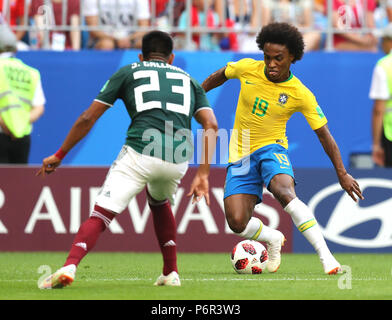 Samara, Russia. 2nd July, 2018. Willian (R) of Brazil vies with Jesus Gallardo of Mexico during the 2018 FIFA World Cup round of 16 match between Brazil and Mexico in Samara, Russia, July 2, 2018. Credit: Lu Jinbo/Xinhua/Alamy Live News Stock Photo