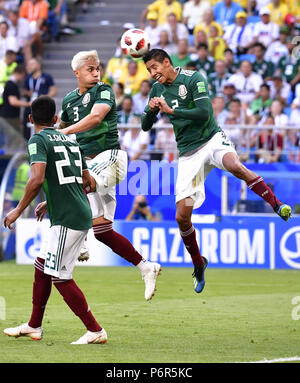 Samara, Russia. 2nd July, 2018. Mexico's Carlos Salcedo (C) and Hugo Ayala (R) compete during the 2018 FIFA World Cup round of 16 match between Brazil and Mexico in Samara, Russia, July 2, 2018. Credit: Chen Yichen/Xinhua/Alamy Live News Stock Photo