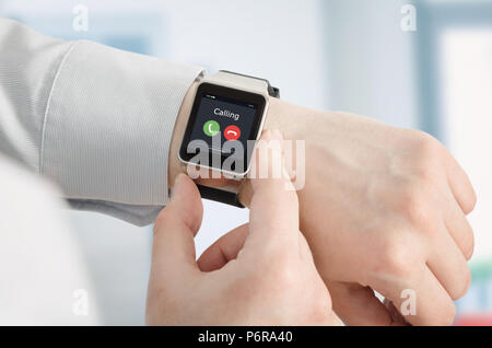 Smartwatch on hand, incoming call on screen, conversation via a smart watch concept Stock Photo