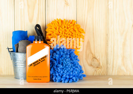 Car wash equipment or car cleaning product such as   brush with mitts and microfiber tank and  etc, on wooden table. Stock Photo