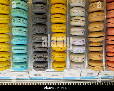 Rows of flavored French macarons for sale at a Japanese bakery in Southeast Asia. Stock Photo