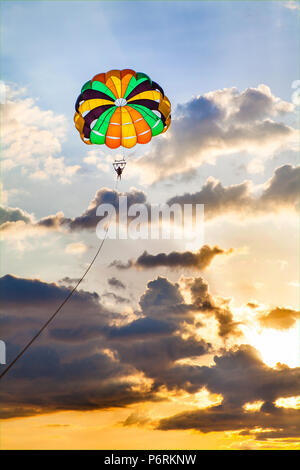 The extreme sport of parasailing in the Philippines with dramatic sky. Stock Photo