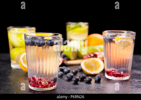 Fruits, berried and vegetables next to glasses with detox water Stock Photo