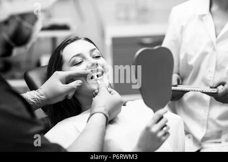 Patient's teeth shade with samples for bleaching treatment. Stock Photo