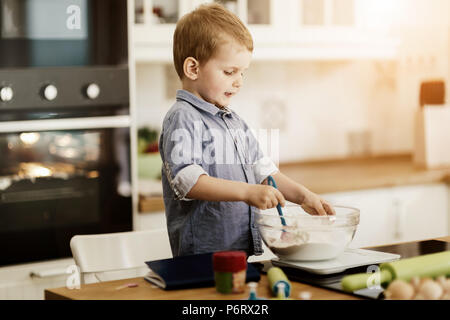 Cute child learning to become a chef Stock Photo