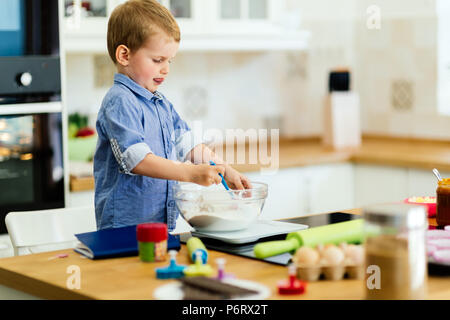 Cute child learning to become a chef Stock Photo