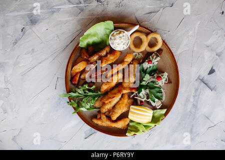 Clay plate full of delicious appetizers. Stock Photo