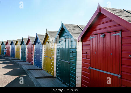 Colourfully painted wooden beach huts in Dawlish on a bright and sunny day, Devon, England, Europe. Stock Photo