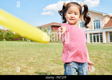 Asian Girl Playing Frisbee Stock Photo