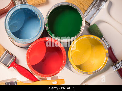 Paint brushes and opened paint cans with colors Stock Photo
