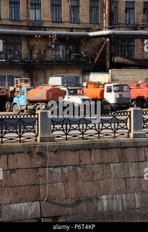 Aging trucks parked in an industrial zone near the commercial harbor of St. Petersburg, Russia Stock Photo