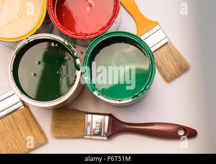 Paint brushes and opened paint cans with colors Stock Photo