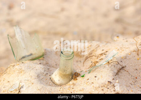 Broken beer glass bottles on a sand Stock Photo
