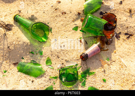 Broken beer glass bottles on a sand Stock Photo
