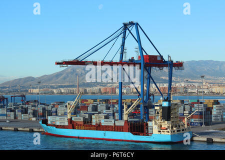 A cargo ship being loaded in the port of Malaga Stock Photo