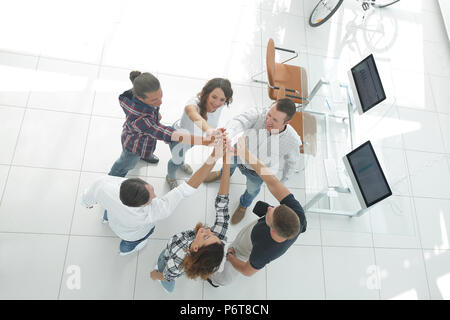 creative team giving each other a high five Stock Photo