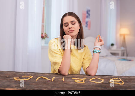 Arrogant teen girl gaming with food Stock Photo