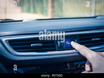 Man's hand touching an ecall button Stock Photo