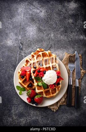 Waffles with strawberry and Vanilla Ice Cream on table Stock Photo - Alamy