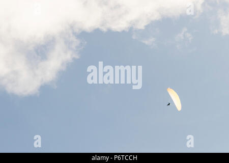 Paragliding in the blue sky with clouds Stock Photo