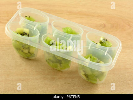 Freshly chopped kiwi fruit in plastic container for making homemade popsicles Stock Photo