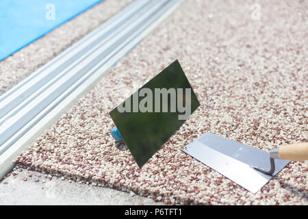 Coloured Concrete Around Pool with tools Stock Photo