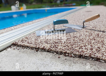 Coloured Concrete Around Pool with tools Stock Photo