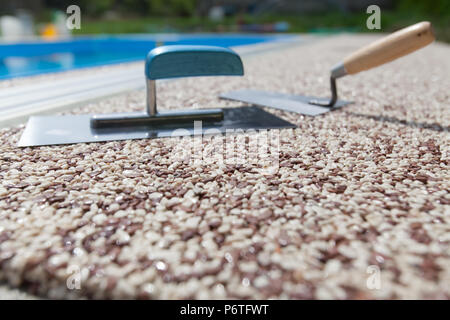 Coloured Concrete Around Pool with tools Stock Photo