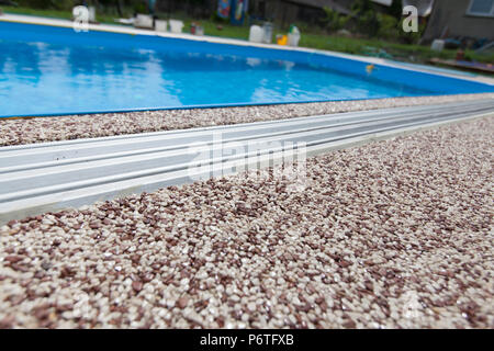 Texture of pebbles in an exposed aggregate foundation Stock Photo