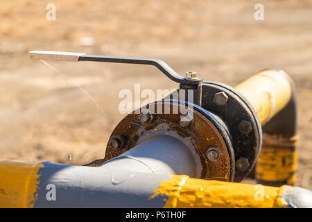 Old rusty gas control valve on the wall Stock Photo