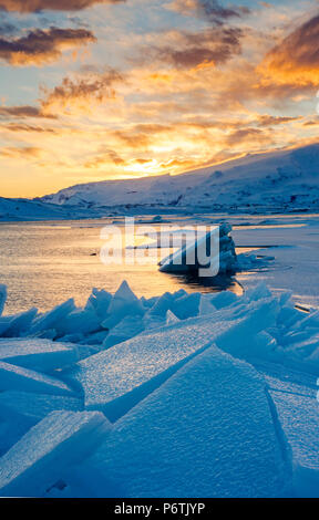 Jokulsarlon glacier lagoon, Iceland, Europe. Blocks of ice in the frozen lagoon on a winter sunset. Stock Photo