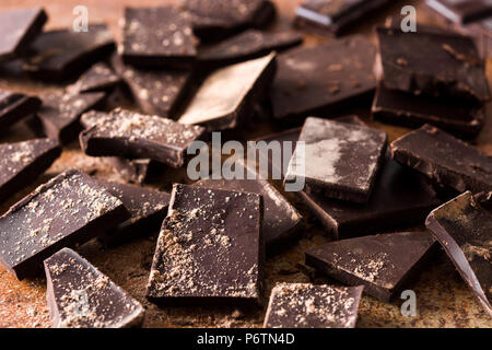 Broken chocolate pieces on brown background Stock Photo