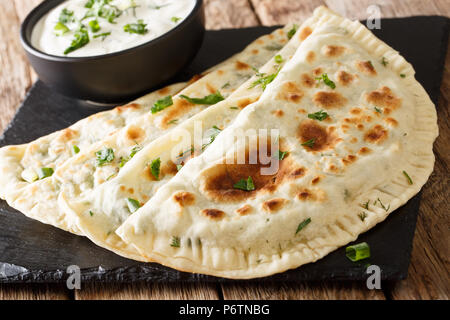Azerbaijan flat bread qutab with greens close-up on the table. horizontal Stock Photo