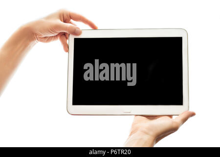 Female hands holding tablet with black screen isolated on white background. Modern mobile device device close up. Mock up concept Stock Photo