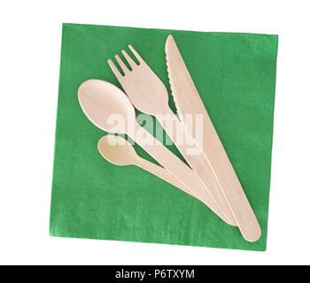 Wooden cutlery, fork, spoon, knife with green paper napkin isolated on white. Stock Photo