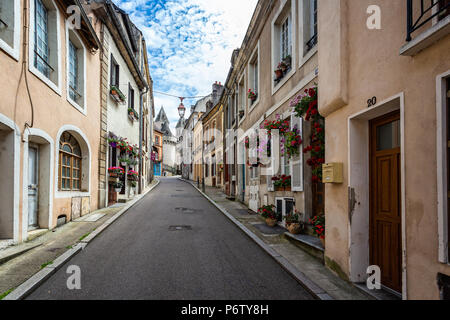 medieval street with colourful flower baskets leading to Autun Cathyedral in Autun, Burgundy, France taken on 17 June 2018 Stock Photo