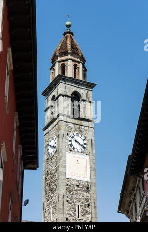 Clock tower of Chiesa Parrocchiale dei Santi Pietro e Paolo at center square in Ascona, Locarno, Switzerland wit blue sky Stock Photo