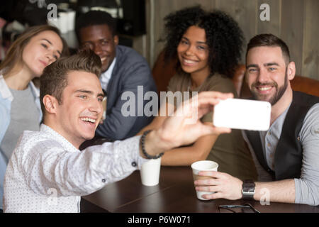 Diverse colleagues smiling for group photo resting in cafe Stock Photo
