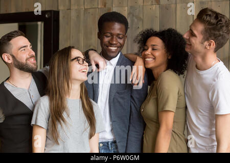 Smiling millennial colleagues having fun together in coffeshop Stock Photo