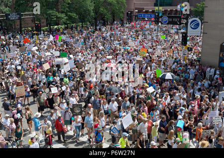 Minneapolis, MN, USA: JUNE 30, 2018: Protesters march in the streets to support the national rally Families Belong Together in downtown Minneapolis.