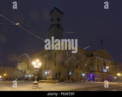 LVIV, UKRAINE - FEBRUARY 04, 2018: Beautiful night winter Rynok Square cityscape.  Some lens flare flrom lamps available. Stock Photo