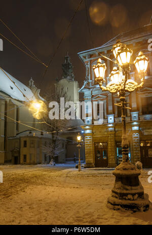 LVIV, UKRAINE - FEBRUARY 04, 2018: Beautiful night winter Rynok Square cityscape. Some lens flare flrom lamps available. Stock Photo