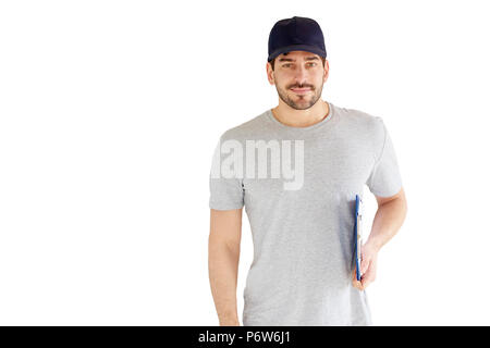 Portrait of handsome young man standing at isolated white background. Smiling carrying man wearing baseball cap and holding clipboard in his hand. Stock Photo